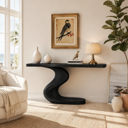 Curved console table displayed beneath framed art in a bright luxury home interior