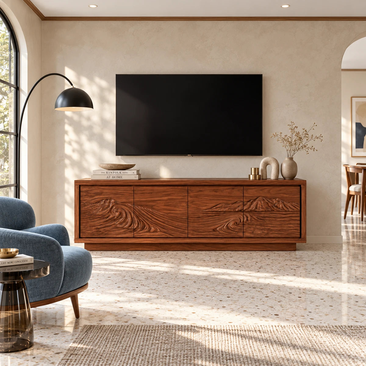 Solid wood TV stand with carved wave and mountain relief across four cabinet doors
