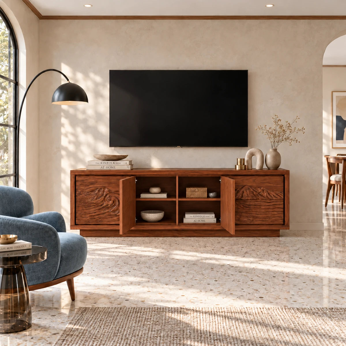 Statement media cabinet in solid wood with ocean wave carving and mountain motif
