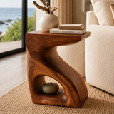 Designer side table with curved supports and visible grain in a calm coastal interior
