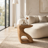 Luxury side table with flowing frame and compact shelf near bright ocean view windows
