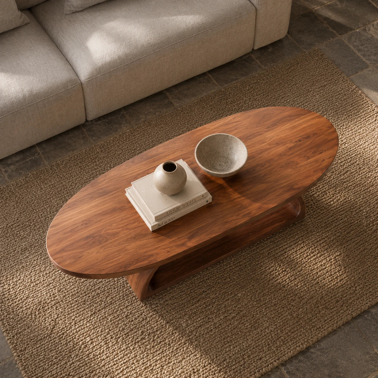 Low profile coffee table with seamless curved pedestal support and rich wood character