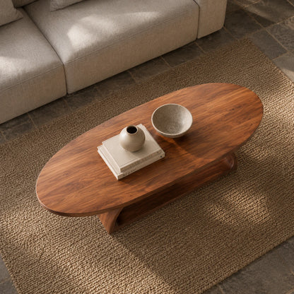 Low profile coffee table with seamless curved pedestal support and rich wood character