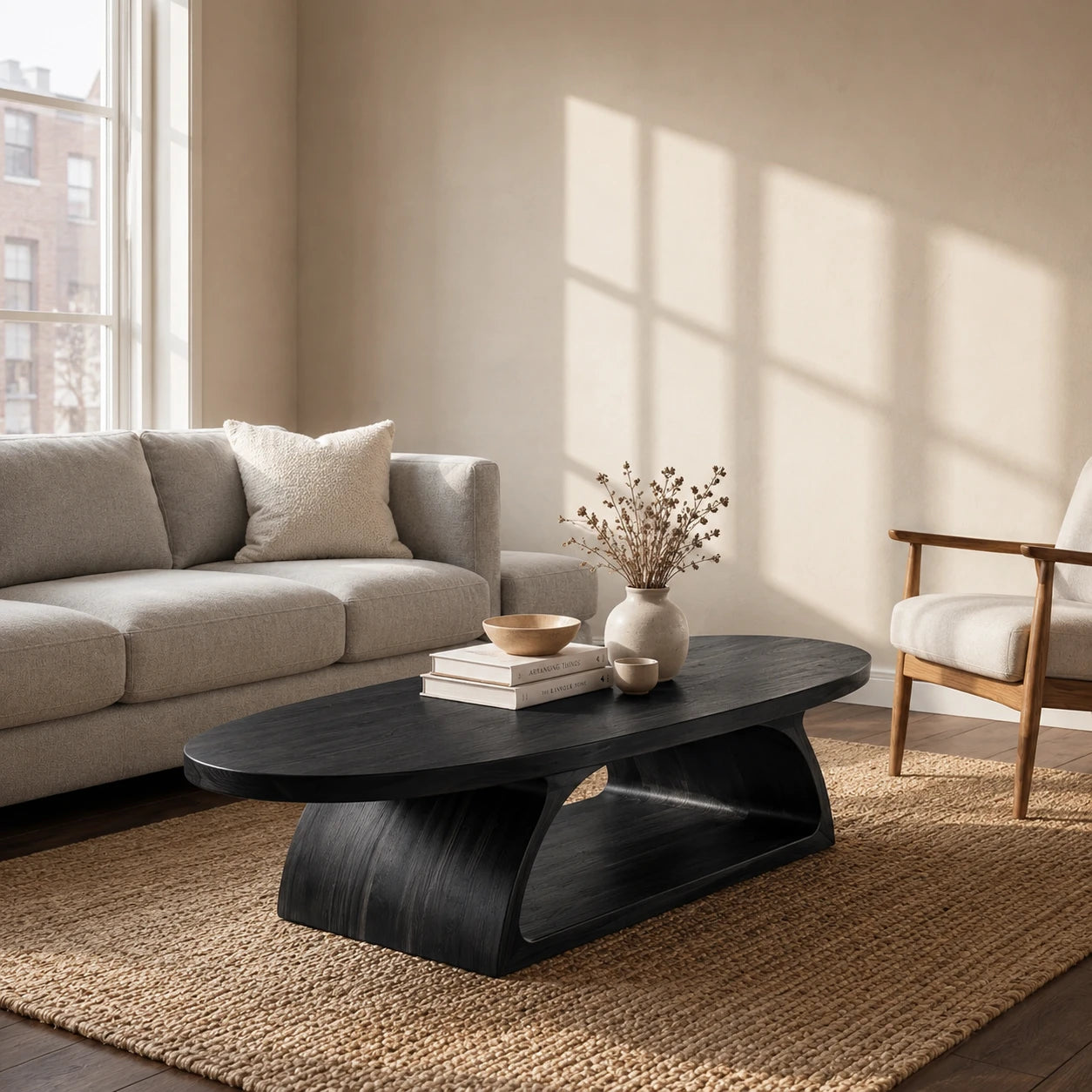 Minimalist coffee table designed with a rounded top and integrated wood pedestal base