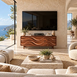 Artistic TV console with layered wave relief and closed storage anchors a living room