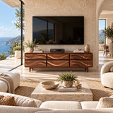 Contemporary TV console with sculpted drawer faces brings texture to an airy living space