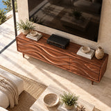 Handcrafted media cabinet with flowing relief fronts adds storage below the television