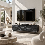 Solid wood TV cabinet with sculpted drawer panels adds depth beneath a mounted television