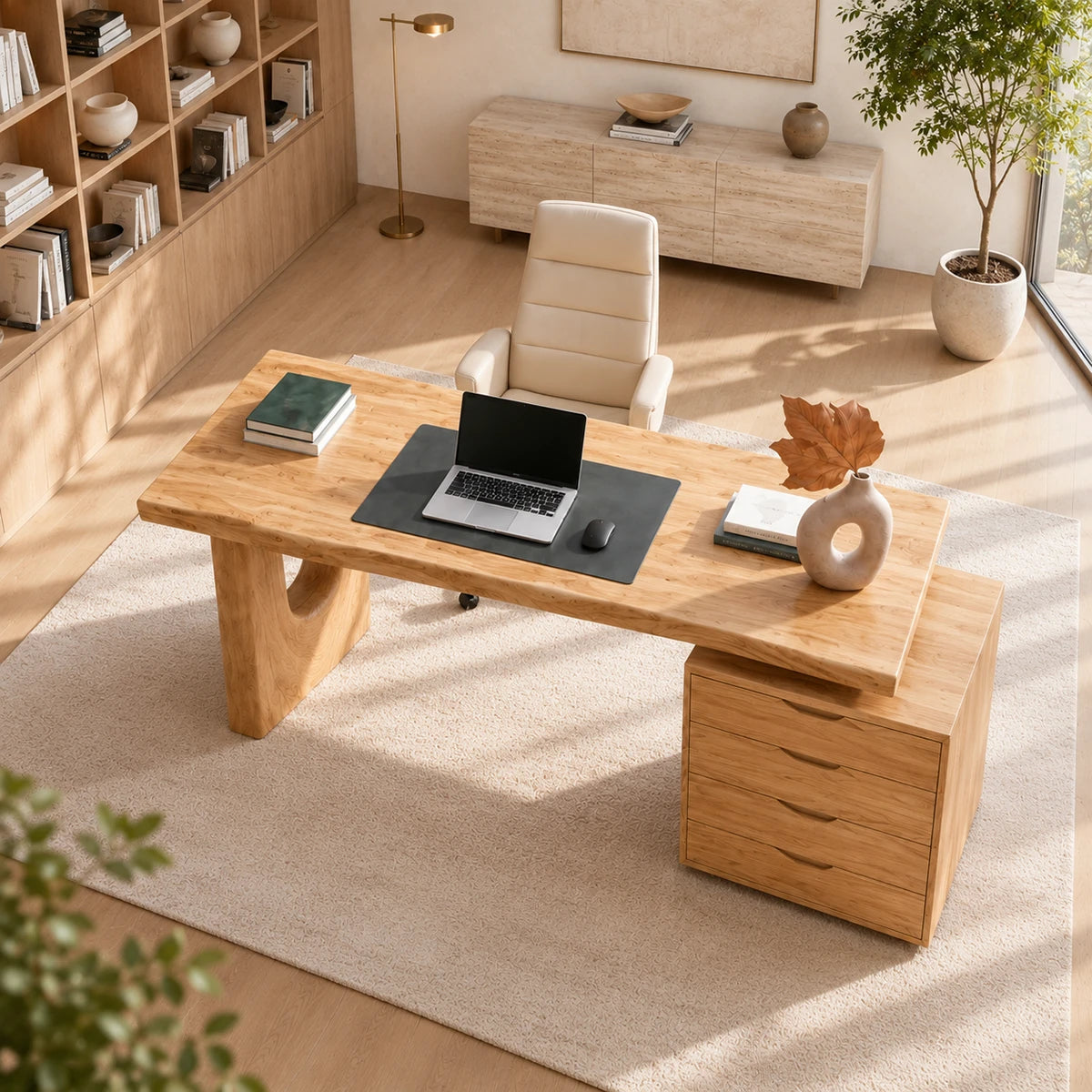 Minimalist office desk with drawer cabinet and sculpted base in a calm modern interior