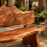 Handcrafted statement bench with sculpted legs and dramatic grain in a serene patio