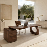 Executive desk with curved open support and drawer pedestal in a refined home office