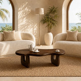 Curved coffee table with sculpted base and dark wood tone finish for modern homes
