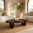 Modern coffee table with dark wood tone finish in a bright coastal living room setting