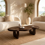 Modern coffee table with dark wood tone finish in a bright coastal living room setting