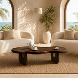 Organic shape coffee table with dark wood tone finish and rounded top for lounging