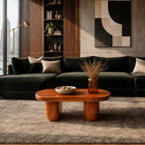 Luxury coffee table with broad rounded top and warm finish in a city apartment interior