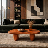 Modern center table with organic proportions and warm wood tone finish in an upscale room