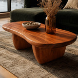 Designer coffee table with curved corners and visible grain in a luxury urban interior