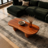 Modern living room coffee table with sculpted supports and a smooth organic silhouette