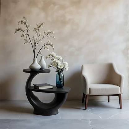 With its black tone finish, the end table blends organic shape and modern styling