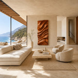 Large wall art panel with sculpted contours adds visual texture to a bright living space