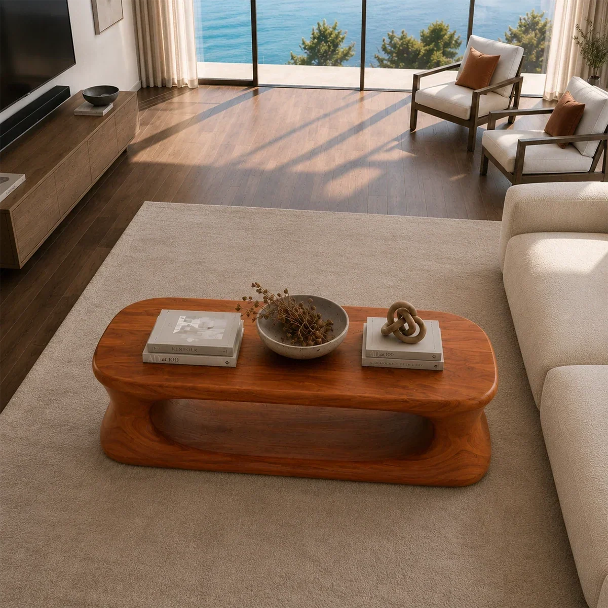 Low profile coffee table with oval open base and natural brown wood-tone finish indoors