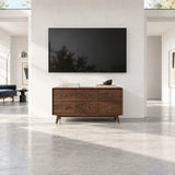 Functional media unit in solid wood with deep drawers and subtle brass ring hardware
