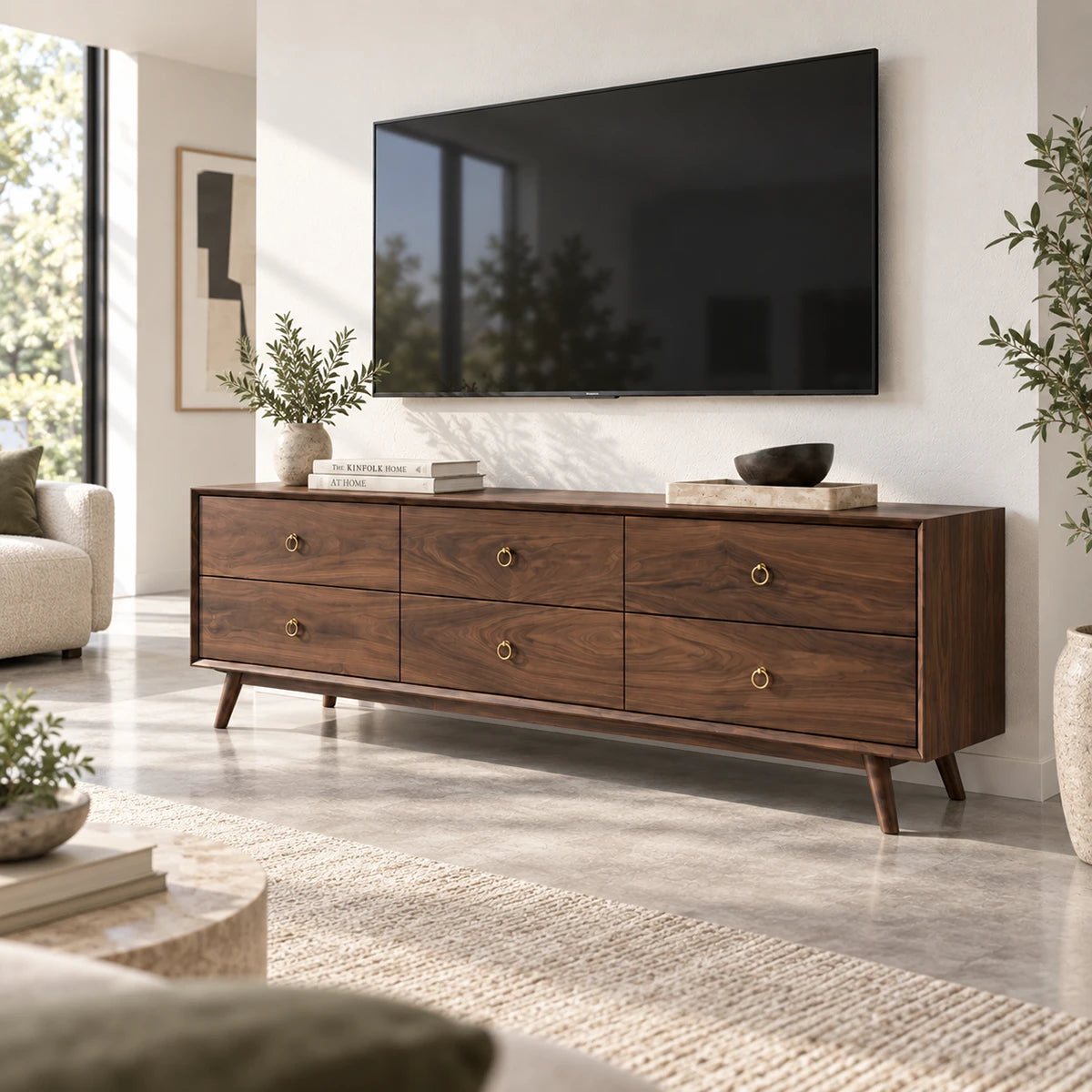 Solid wood TV stand with six drawers, brass ring pulls, and tapered legs for storage
