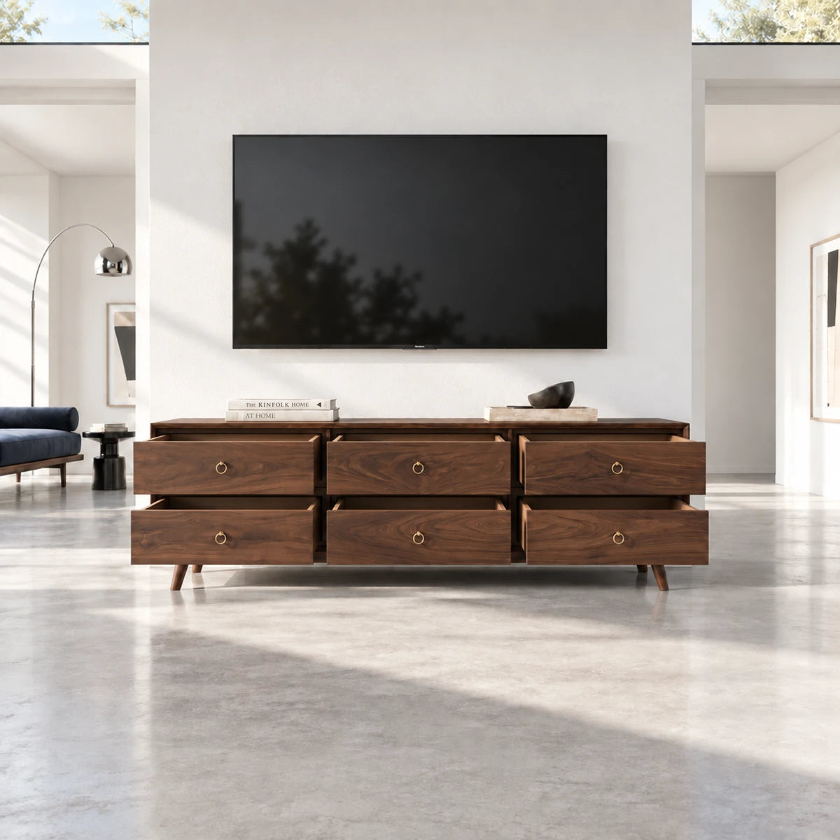 Wide media cabinet in solid wood with tapered legs and generous hidden drawer storage
