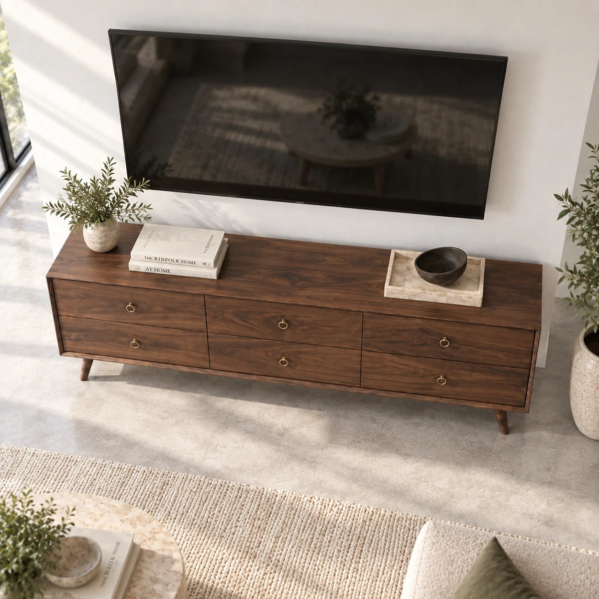 Designer entertainment unit in solid wood with six drawers and sleek brass pulls
