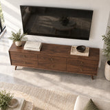 Designer entertainment unit in solid wood with six drawers and sleek brass pulls
