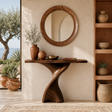Sculptural console table with a twisted pedestal base in a warm coastal interior