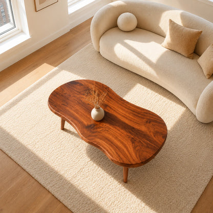 Designer coffee table with fluid contours and handcrafted solid wood construction
