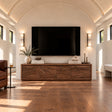 Solid wood TV stand with carved wave front and low-profile living room storage base
