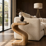 Luxury side table with a sculptural open frame and compact top in a bright interior
