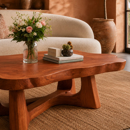 Low profile coffee table with rounded organic contours and sturdy wood legs for cozy rooms