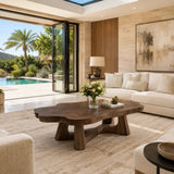 Living room coffee table with a broad freeform surface and artistic base for modern homes