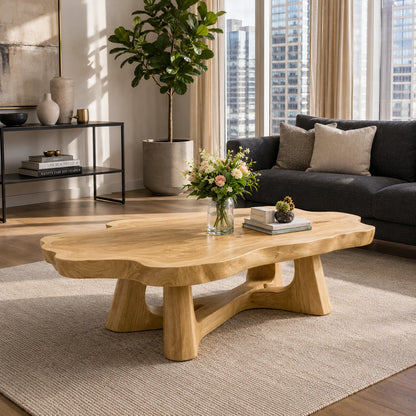 Statement coffee table with flowing edges and substantial supports for warm interiors