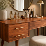 Cosmetic vanity table styled beneath a round mirror in a calm contemporary bedroom