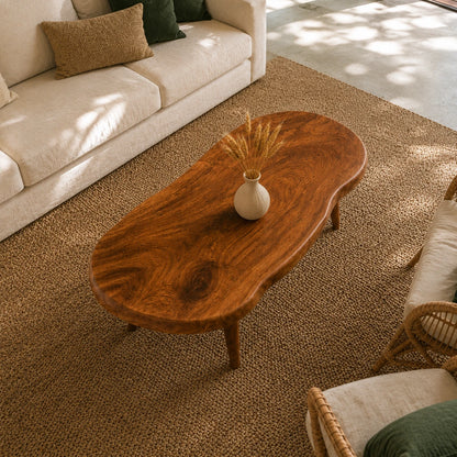 Low profile coffee table featuring an organic top and handcrafted solid wood base