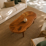 Low profile coffee table featuring an organic top and handcrafted solid wood base