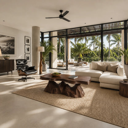Sculptural coffee table featuring an organic slab top in a luxury indoor outdoor lounge
