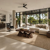 Sculptural coffee table featuring an organic slab top in a luxury indoor outdoor lounge