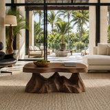 Artisan coffee table with organic lines and a hand carved base for luxe interiors
