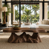 Luxury coffee table with carved pedestal detailing and an artistic natural wood top