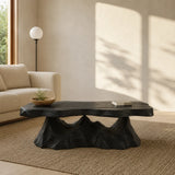 Designer coffee table with an organic slab profile in a bright open concept lounge