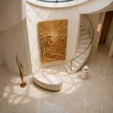 Decorative wood wall decor with sunburst and palm motifs enhances a serene foyer
