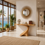 Organic modern console table styled beneath a sunburst mirror in a warm airy room