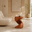 Sculptural end table with a twisted base and warm wood tone finish in a calm interior