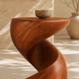 Designer side table with sculpted curves and a compact top for modern room styling